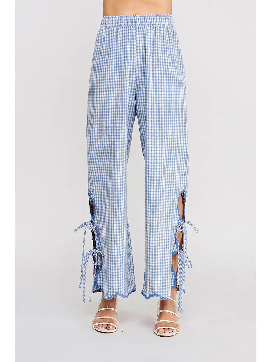 Blue checkered pants with ruffled edges on a white background