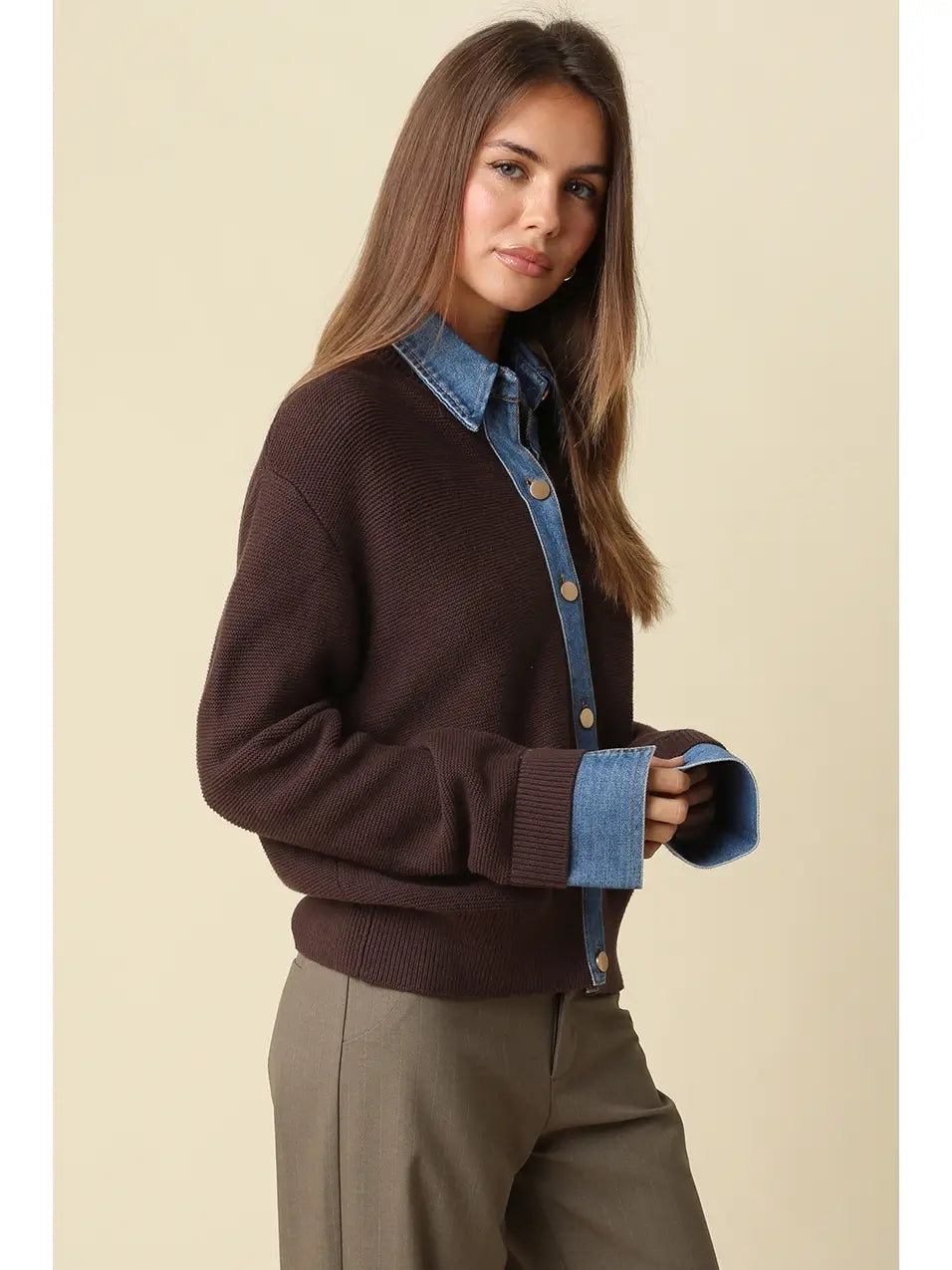 Women wearing a brown and denim sweater with brown pants. 