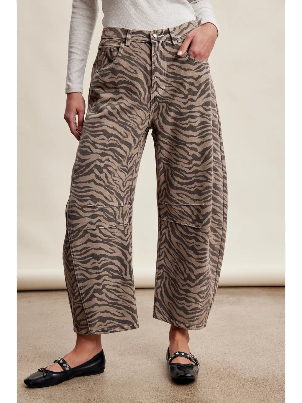 Women wearing zebra print barrel jeans. 