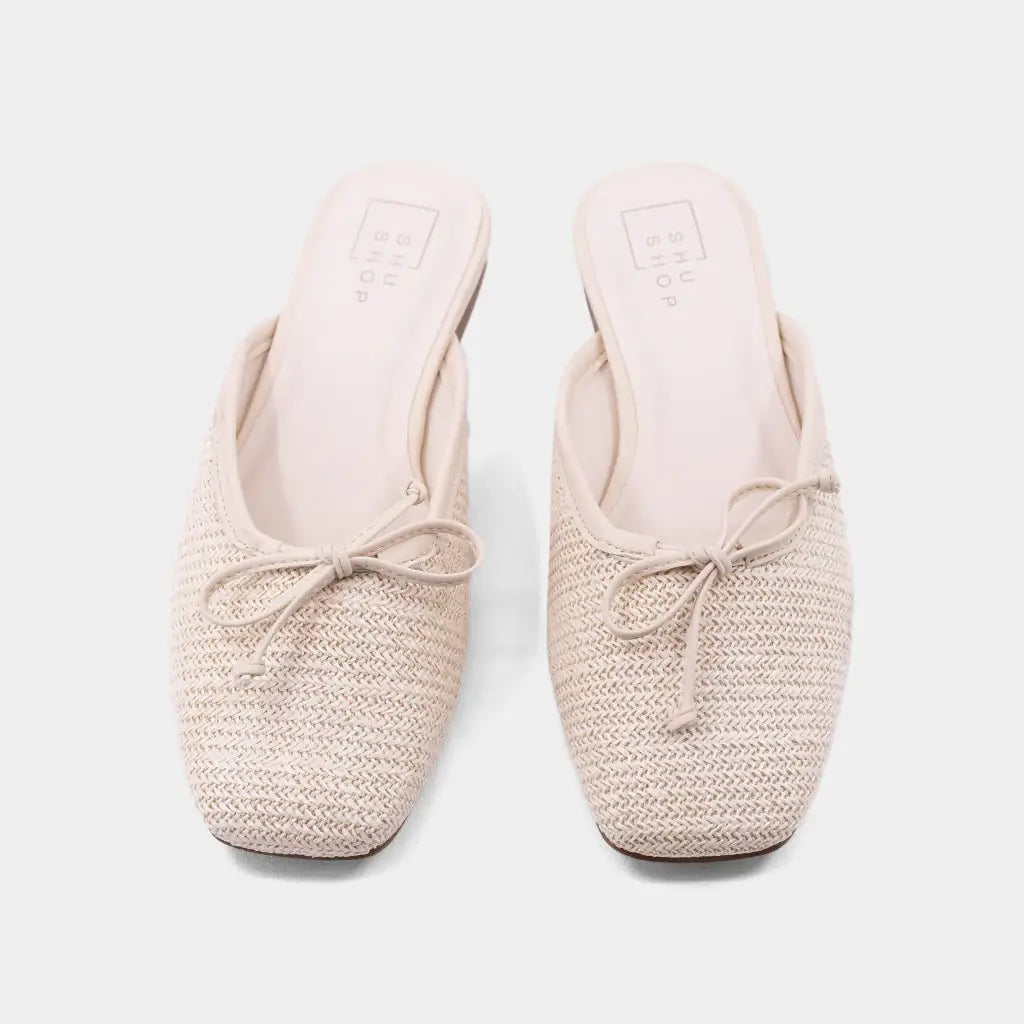Beige woven flat shoe on a light gray background