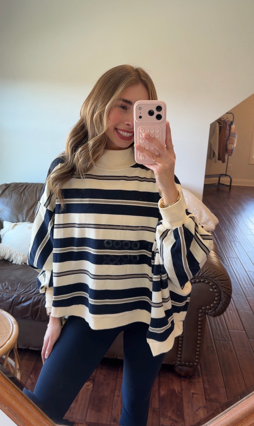 Person wearing a striped sweater in a living room setting