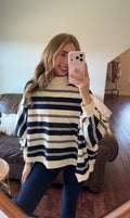 Person wearing a striped sweater in a living room setting