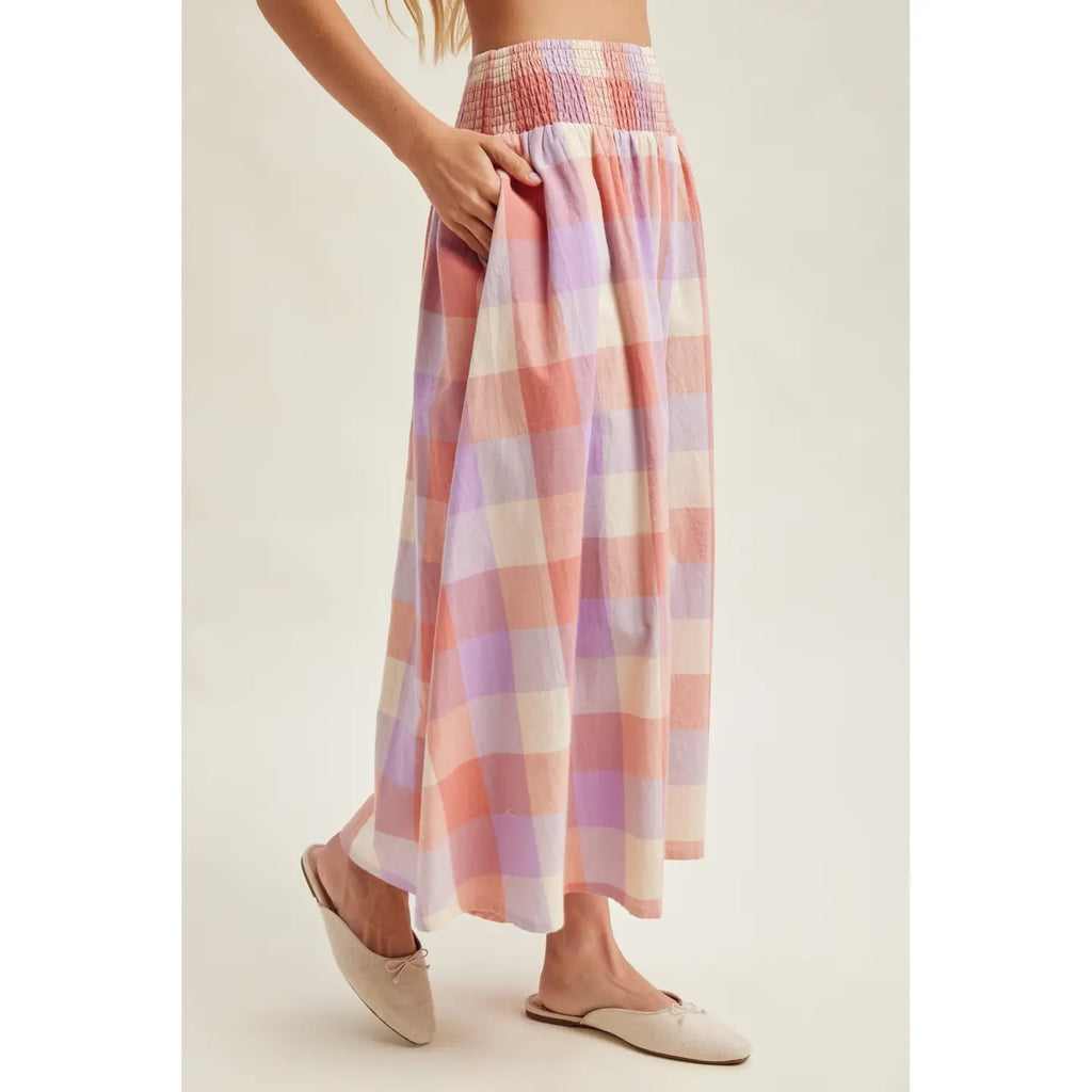 Pastel plaid skirt worn by a person on a plain background