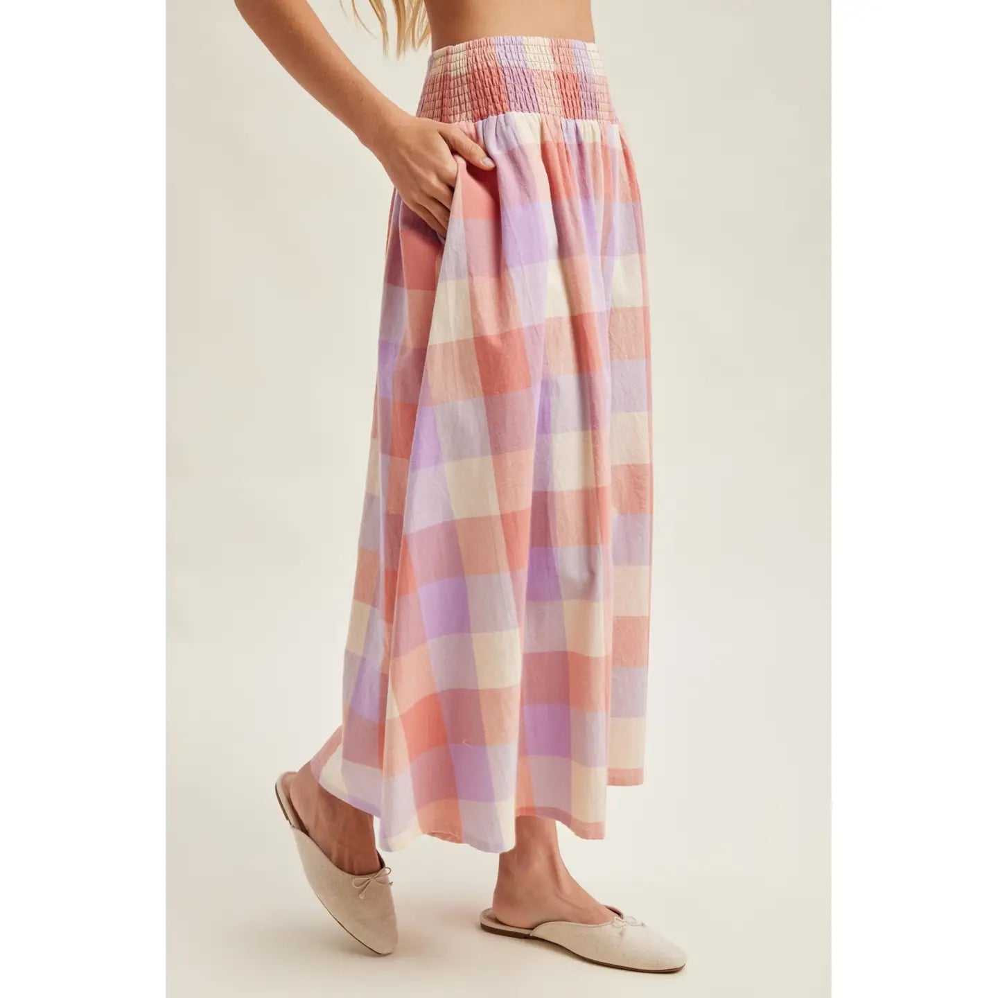 Pastel plaid skirt worn by a person on a plain background