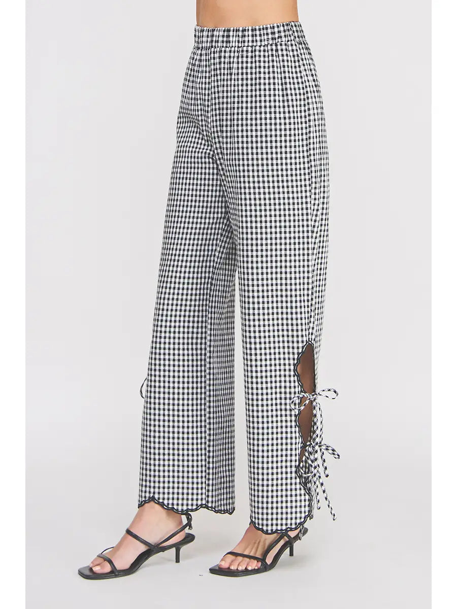 Black and white checkered pants with a side slit on a white background