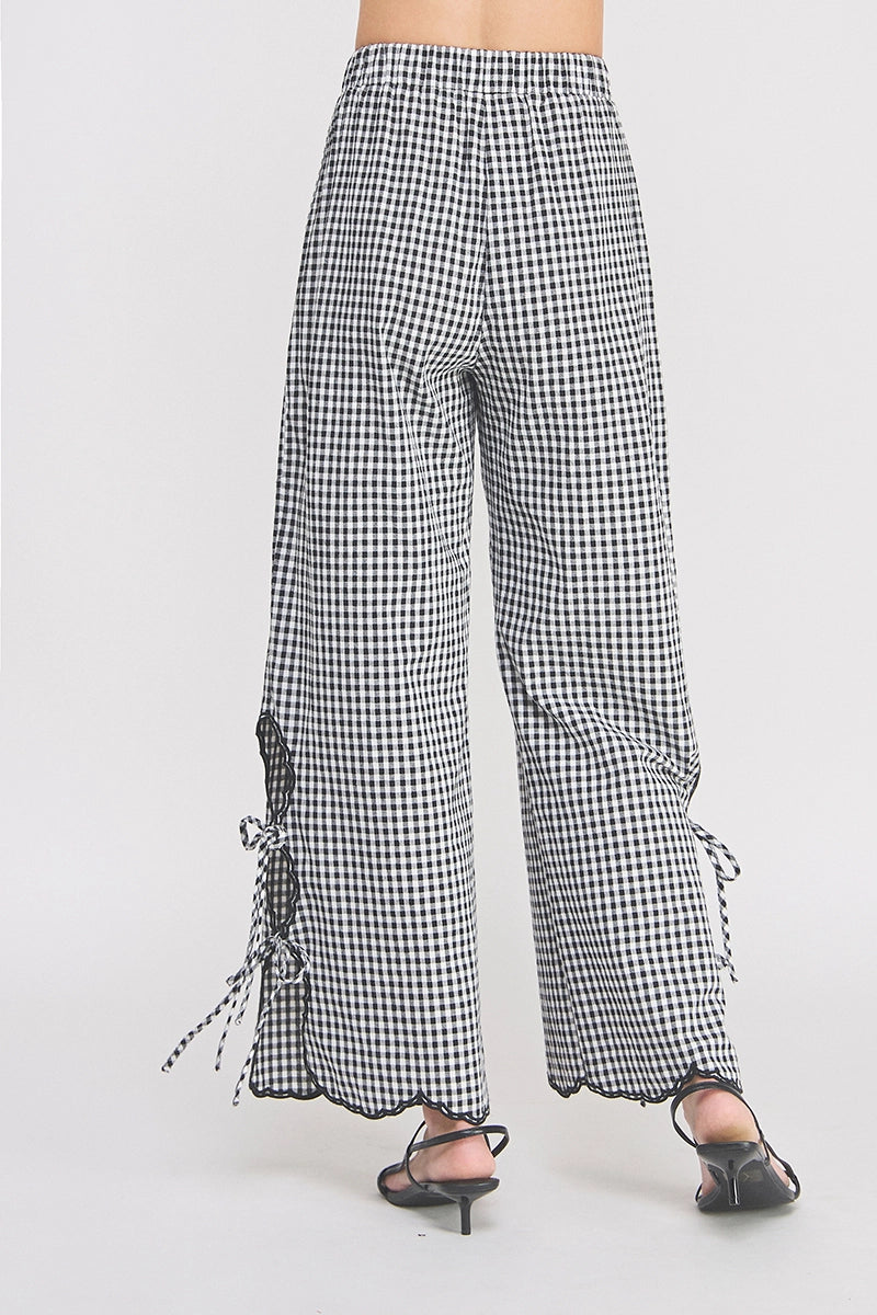 Gingham checkered pants with ruffled hem on a white background