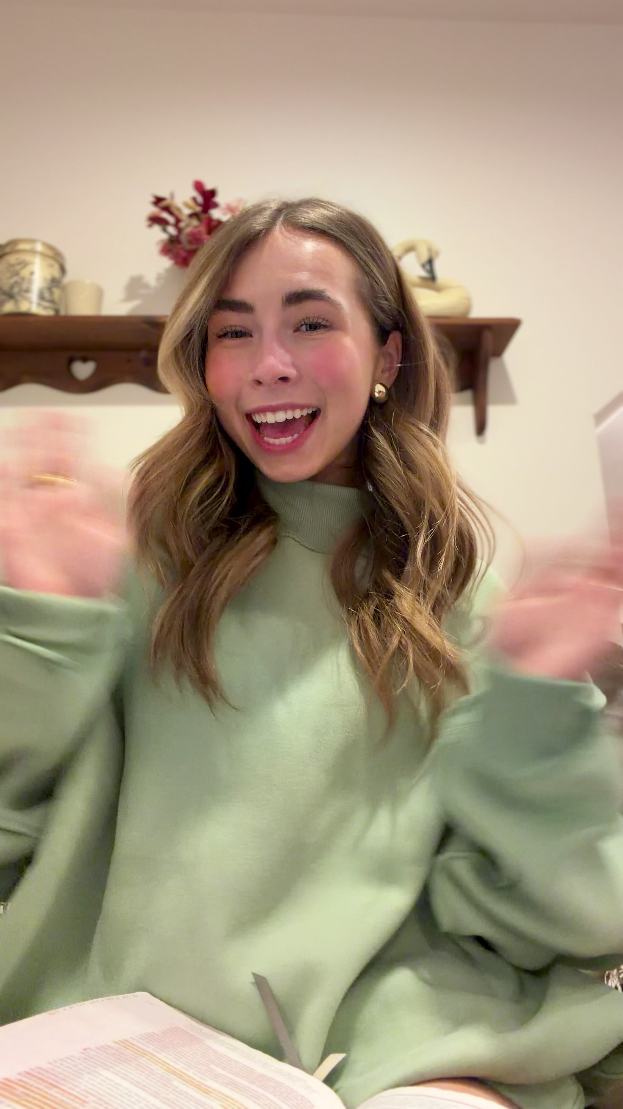 Woman sharing bible verse in a green sweatshirt. 